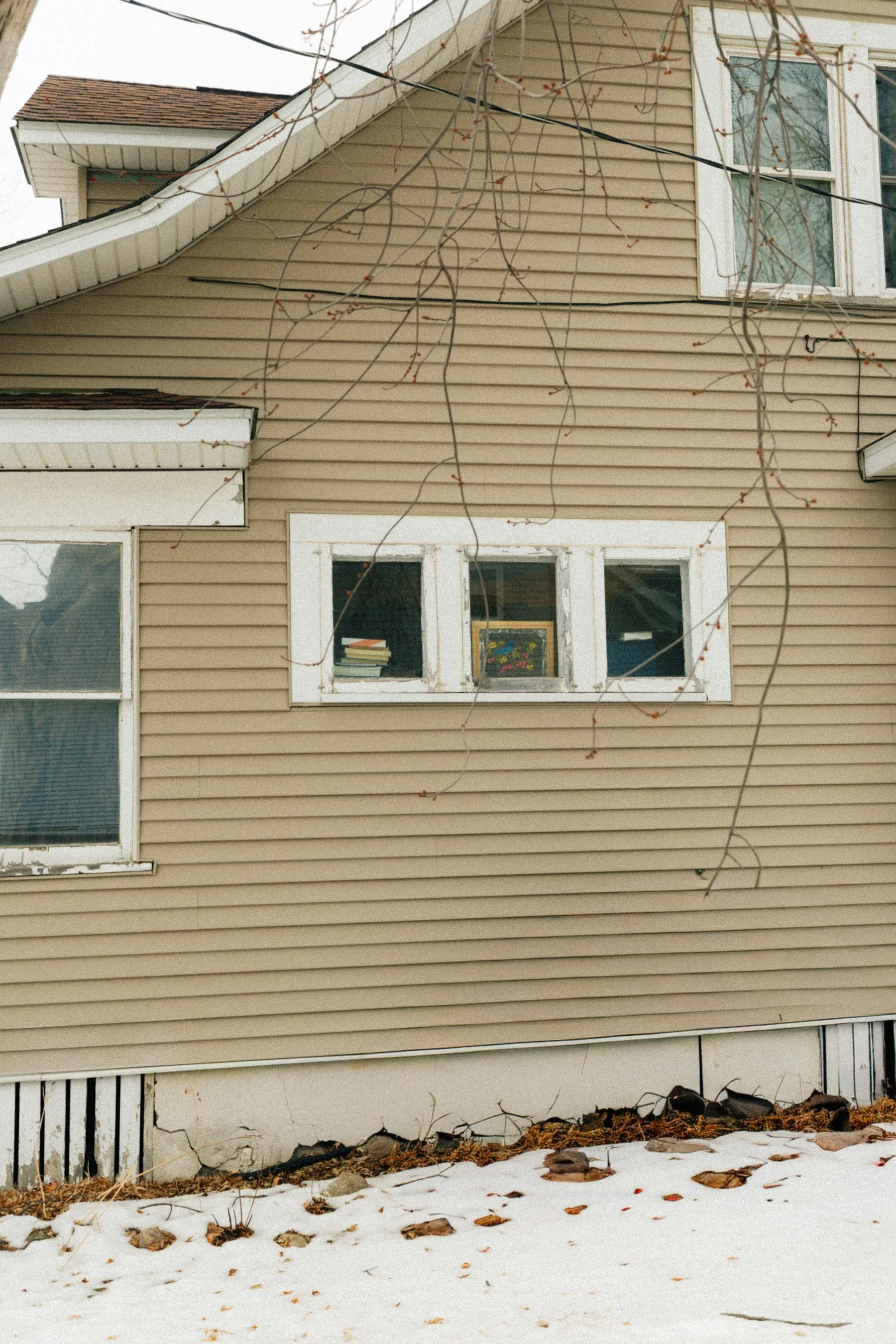 Older home with lap siding and painted window trim